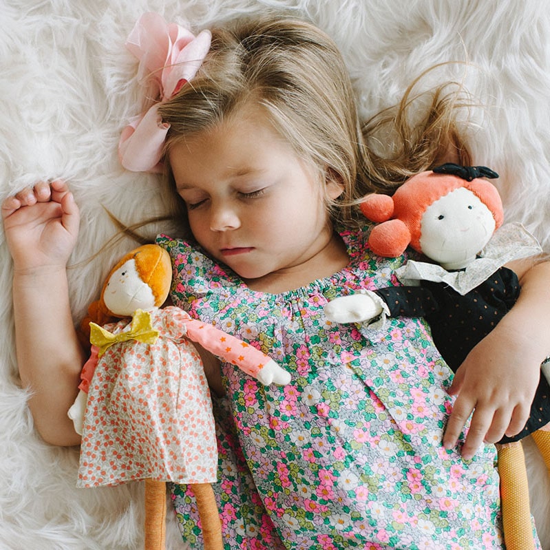 little girl sleeping with moulin roty parisienne dolls